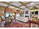 Spacious living room with beamed ceilings, a formal dining area, and elegant furnishings, with bright natural light at 958 Tamarack Cir N Dr, Indianapolis, IN 46260
