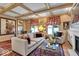 Charming living room with wood paneled walls, beam ceilings, and decorative accents for a cozy atmosphere at 958 Tamarack Cir N Dr, Indianapolis, IN 46260