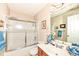 Bathroom featuring a tub and shower combination with glass doors, accompanied by a vanity and mirror at 963 Wickham Ct # 103, Carmel, IN 46032