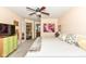 Spacious bedroom features carpet flooring, a large bed, closet access, and natural light at 963 Wickham Ct # 103, Carmel, IN 46032