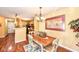 Inviting dining room with decorative chandelier and a view into the adjacent kitchen, perfect for Gathering gatherings at 963 Wickham Ct # 103, Carmel, IN 46032