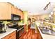 Well-lit kitchen with wooden cabinets and countertops, offering open views to the dining area for easy entertaining at 963 Wickham Ct # 103, Carmel, IN 46032