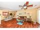 Comfortable living room featuring hardwood floors, a ceiling fan, and an open layout into the dining area at 963 Wickham Ct # 103, Carmel, IN 46032