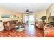 Bright living room with a glass sliding door to the backyard and a cozy seating area for relaxing or entertaining at 963 Wickham Ct # 103, Carmel, IN 46032
