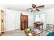 Living room features a ceiling fan, neutral walls, with a cabinet, desk and cozy furniture at 963 Wickham Ct # 103, Carmel, IN 46032