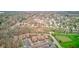 This is an aerial view of a neighborhood showcasing houses, apartment buildings, parking lots, and trees at 102 Knoll Ct # D, Noblesville, IN 46062