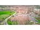 A landscape aerial view shows apartment buildings, parking lots, garages, and lots of greenery at 102 Knoll Ct # D, Noblesville, IN 46062