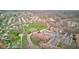 This aerial view showcases an apartment complex, neighborhood, a field, and a row of garages at 102 Knoll Ct # D, Noblesville, IN 46062
