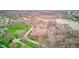 Aerial view of apartment buildings and lake with individual garages and parking at 102 Knoll Ct # D, Noblesville, IN 46062