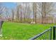 Green backyard with chain link fence and two benches at 102 Knoll Ct # D, Noblesville, IN 46062