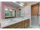Bathroom with double sink vanity, large mirror, and white tile at 102 Knoll Ct # D, Noblesville, IN 46062