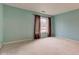 Bright bedroom with neutral carpet, light blue walls and a window with brown curtains at 102 Knoll Ct # D, Noblesville, IN 46062