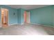 Spacious bedroom features light blue walls, neutral carpet, and two doorways at 102 Knoll Ct # D, Noblesville, IN 46062