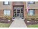 Inviting condo building entrance with brick accents, glass doors and an American flag displayed at 102 Knoll Ct # D, Noblesville, IN 46062