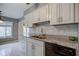 Bright kitchen featuring white cabinets, granite countertops, and a stylish backsplash at 102 Knoll Ct # D, Noblesville, IN 46062