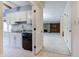 Well-lit kitchen with white cabinets, granite countertops, and a peek into the cozy living room at 102 Knoll Ct # D, Noblesville, IN 46062