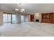 Spacious living room featuring a stone fireplace, built-in shelving, and sliding glass doors to a patio at 102 Knoll Ct # D, Noblesville, IN 46062
