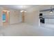 Open-concept living room with beige walls, white carpet and transitions into kitchen area at 102 Knoll Ct # D, Noblesville, IN 46062
