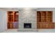 Cozy living room featuring a stone fireplace flanked by custom built-in wooden shelving at 102 Knoll Ct # D, Noblesville, IN 46062