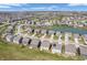 A bird's-eye view showcases the well-planned community with its serene lake and uniformly designed residences at 1075 Barberry Dr, Greenwood, IN 46143