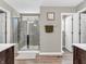 A modern bathroom features a tiled glass shower and wood look flooring at 1075 Barberry Dr, Greenwood, IN 46143
