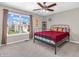 Bright bedroom with black metal bed frame and large windows offering exterior neighborhood views at 1075 Barberry Dr, Greenwood, IN 46143