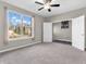Spacious bedroom with neutral walls, ceiling fan, and a large window overlooking neighborhood at 1075 Barberry Dr, Greenwood, IN 46143