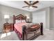 Cozy bedroom showcasing an ornate wooden bed frame with matching nightstands and a ceiling fan at 1075 Barberry Dr, Greenwood, IN 46143