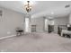 Open bonus room with soft carpet, natural light, and view of the hallway at 1075 Barberry Dr, Greenwood, IN 46143