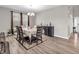 Elegant dining room featuring wood floors, modern chandelier, and seating for six at 1075 Barberry Dr, Greenwood, IN 46143