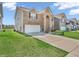 Two-story brick house showcasing a well-maintained lawn and a driveway leading to a two-car garage at 1075 Barberry Dr, Greenwood, IN 46143