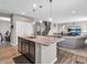 Kitchen island features stainless steel dishwasher, lots of room, and an open floor plan into the living room at 1075 Barberry Dr, Greenwood, IN 46143