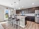 Kitchen island with granite countertops, seating for three, and stainless steel appliances at 1075 Barberry Dr, Greenwood, IN 46143