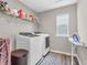 Functional laundry room equipped with washer, dryer, shelving, and natural light from a window at 1075 Barberry Dr, Greenwood, IN 46143