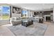 Inviting living space features a large sectional sofa, a glass-top coffee table, and an open layout to the kitchen at 1075 Barberry Dr, Greenwood, IN 46143