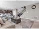 Open-concept living room with a comfortable sofa, leading to a kitchen featuring dark cabinetry at 1075 Barberry Dr, Greenwood, IN 46143