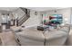 Spacious living area with plush seating, a modern entertainment center, and a staircase leading to the upper level at 1075 Barberry Dr, Greenwood, IN 46143