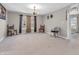 Cozy living room with neutral carpet, chandelier, and lots of natural light at 1075 Barberry Dr, Greenwood, IN 46143