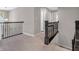 Spacious hallway with neutral walls, soft carpet and decorative dark railings at 1075 Barberry Dr, Greenwood, IN 46143