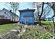 View of the backyard with a small back porch and a detached garage nearby at 1145 N Belleview Pl, Indianapolis, IN 46222