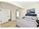 Virtual Staged bedroom with a white bed frame, wood floors and an ensuite bathroom at 1145 N Belleview Pl, Indianapolis, IN 46222