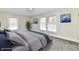 Bright bedroom featuring neutral walls, plush carpet, and a comfortable queen-size bed with stylish bedding at 1145 N Belleview Pl, Indianapolis, IN 46222