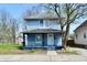Charming two-story home featuring a covered front porch and light blue siding at 1145 N Belleview Pl, Indianapolis, IN 46222