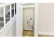 A practical laundry closet located near a staircase, featuring hookups for a washer and dryer at 1145 N Belleview Pl, Indianapolis, IN 46222