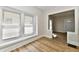 Sunlit living room featuring large windows, neutral walls, and wood-look flooring at 1145 N Belleview Pl, Indianapolis, IN 46222