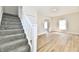 A staircase leading to a carpeted second floor with an entrance to a living room at 1145 N Belleview Pl, Indianapolis, IN 46222