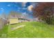 Fenced in backyard with a shed, patio, and green grass at 115 King Arthur Dr, Franklin, IN 46131