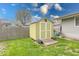 Backyard shed in a fenced yard, with green grass at 115 King Arthur Dr, Franklin, IN 46131