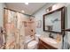Cozy bathroom with tiled shower, framed mirror, vanity, and soft lighting at 115 King Arthur Dr, Franklin, IN 46131