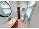 This half-bathroom features neutral walls, wood cabinets, a framed mirror, and tile flooring at 115 King Arthur Dr, Franklin, IN 46131